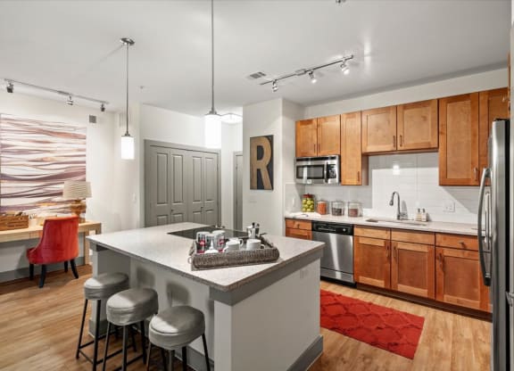 a kitchen with a large island and wooden cabinets
