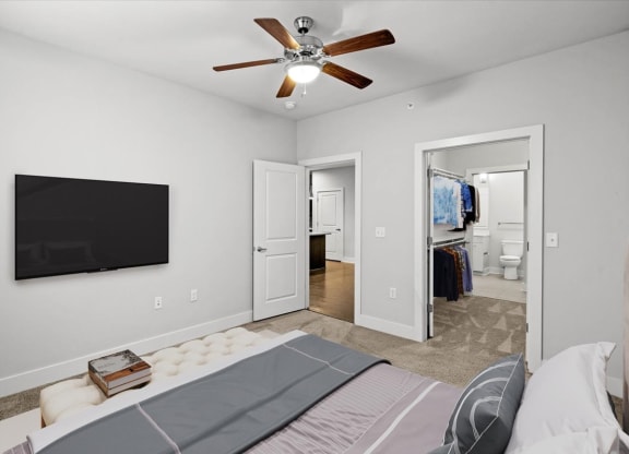 a bedroom with a bed and a ceiling fan