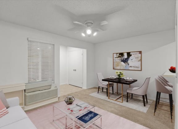a living room with a dining room table and a ceiling fanat Millcreek Woods Apartments, Olathe, KS, 66061