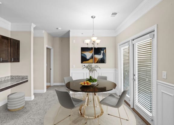 a dining room with a table and chairs