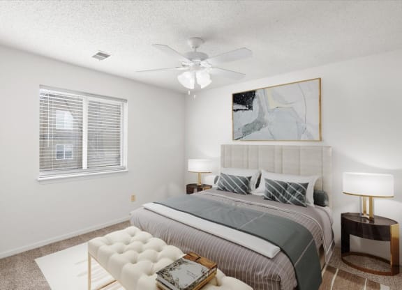 a bedroom with a bed and a ceiling fan at Deerfield Apartments, Olathe, Kansas