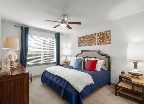 a bedroom with a bed and a ceiling fan