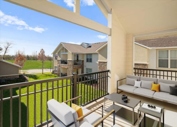 a patio with a couch and a table on a balcony