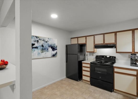 a kitchen with a stove and a refrigeratorat Millcreek Woods Apartments, Kansas, 66061