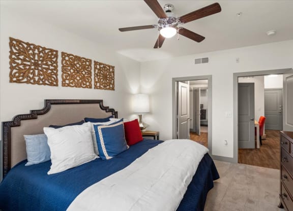 a bedroom with a large bed and a ceiling fan