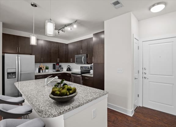 a kitchen with a counter top with a bowl of fruit