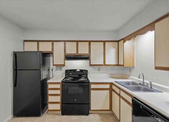 a kitchen with a stove refrigerator and sinkat Millcreek Woods Apartments, Olathe