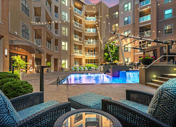 A large building with a pool in the middle of a courtyard.