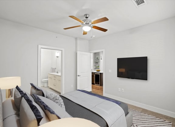 a bedroom with a bed and a ceiling fan