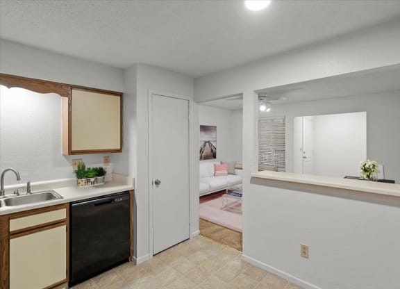 a kitchen with a view of a living roomat Millcreek Woods Apartments, Olathe, Kansas