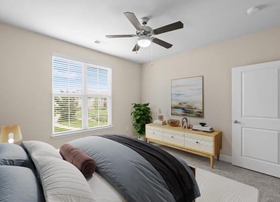 a bedroom with a bed and a ceiling fan