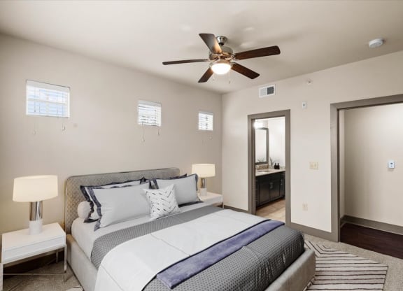 a bedroom with a large bed and a ceiling fan