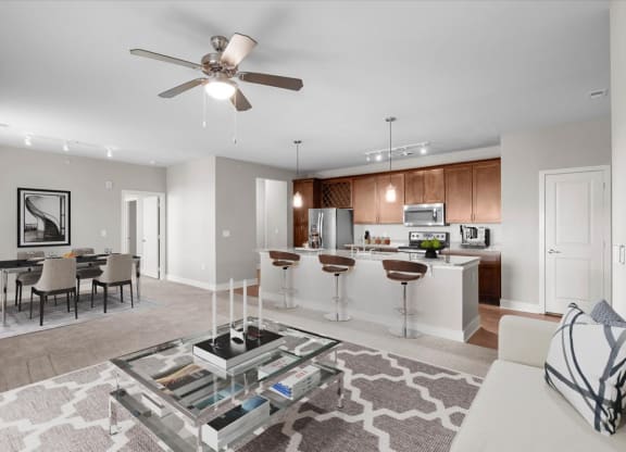 a living room and kitchen with a ceiling fan