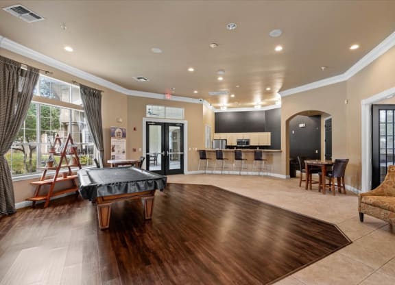a game room with a foosball table and a bar