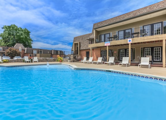 An outdoor pool with a sun deck and lounge chairs at a smoke-free community.
