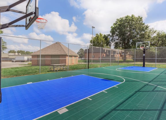 An outdoor sports court for basketball, tennis, recreation.