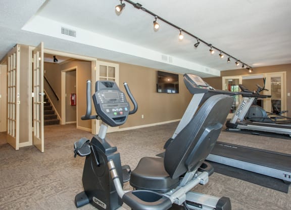 A fitness center with recumbent bike and treadmills.