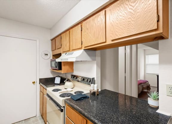 a kitchen with a counter top and a stove at Wind River Lodge, Lenexa, Kansas