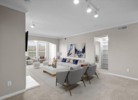 a living room with a couch and a table at The Clairborne Apartment Homes, Grand Prairie, Texas