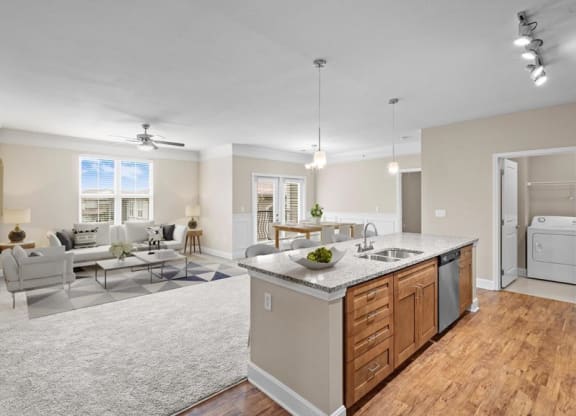 a kitchen with an island and a living room with a couch