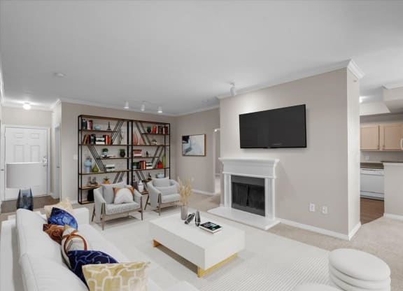 a living room with a fireplace and a bookshelf at The Clairborne Apartment Homes, Texas
