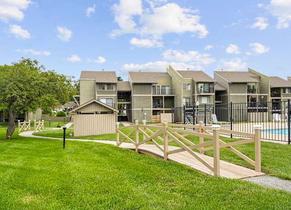 A row of houses with a wooden fence in front.