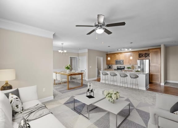 a living room and kitchen with a ceiling fan