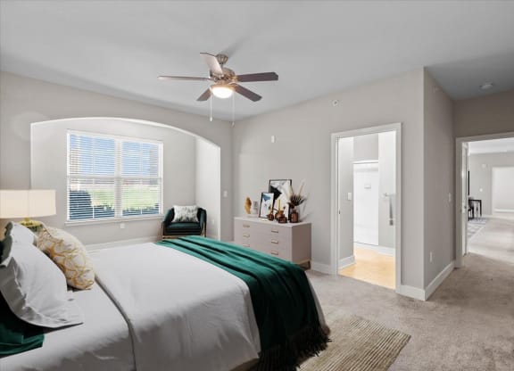 a bedroom with a bed and a ceiling fan