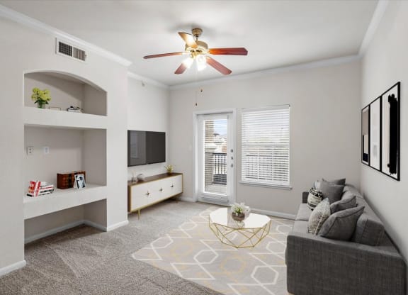 a living room with a ceiling fan and a window