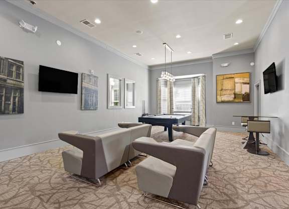 a living room with couches and a ping pong table at Stonepost Crossing Apartments, Overland Park, Kansas