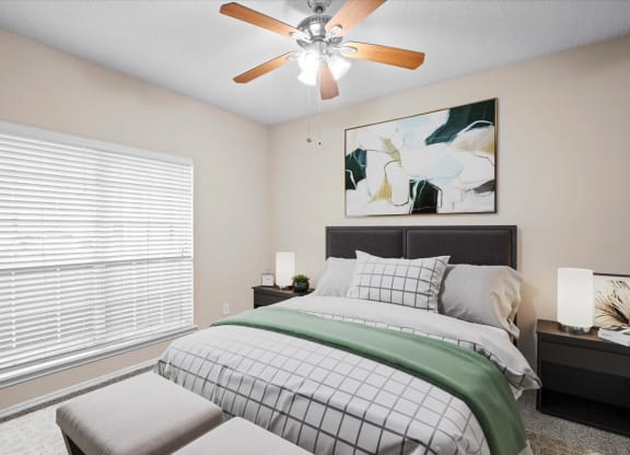 a bedroom with a large window and a ceiling fan at Creekview Apartment Homes, Dallas, TX