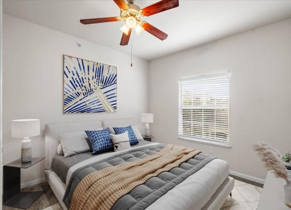 a bedroom with a bed and a ceiling fan
