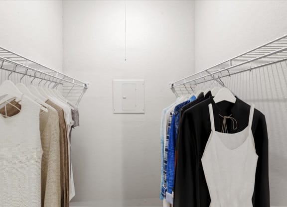 a small walk in closet with white walls and a white light switch on the wall at Creekview Apartment Homes, Dallas, TX
