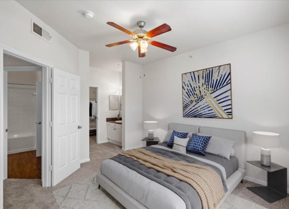 a bedroom with a bed and a ceiling fan