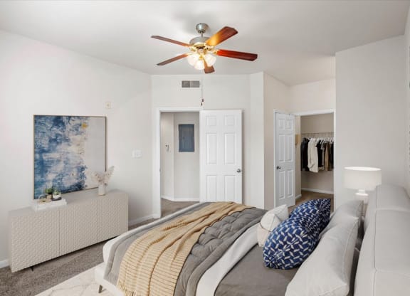 a bedroom with a large bed and a ceiling fan