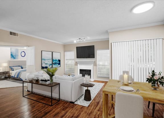a living room with a couch a table and a fireplace at Creekview Apartment Homes, Texas, 75254