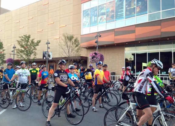 A group of cyclists are lined up and ready to start a race. at Residences at Prairiefire Apartment Homes, Overland Park, KS, 66223