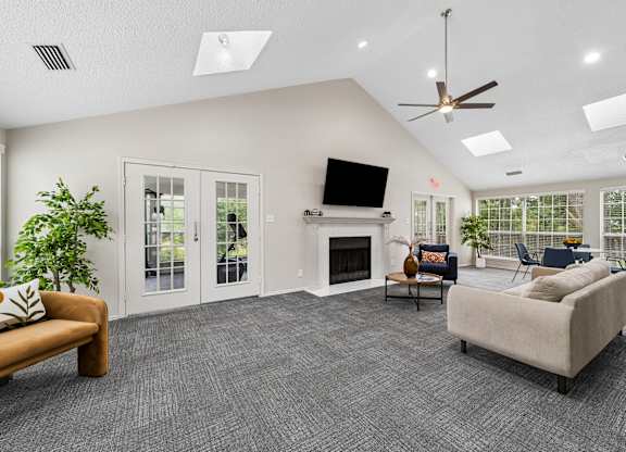 A living room with a fireplace, a television, and a couch.
