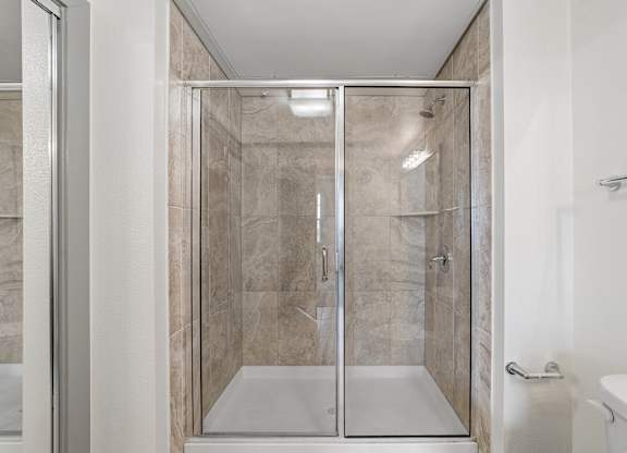 A modern bathroom with a walk-in shower.