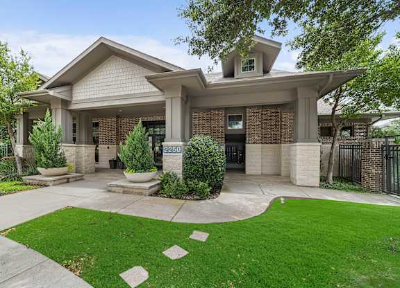 A house with a green lawn in front.