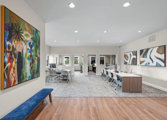 a conference room with a table and chairs and a painting