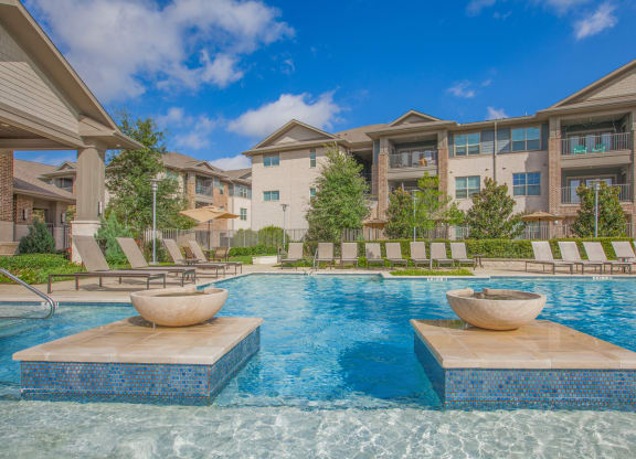 pool with apartment building at Ovation at Lewisville Apartments, Lewisville, Texas