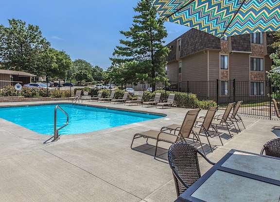 Swimming pool with lounge seating at Bristol Pointe Apartments in Olathe, Kansas.