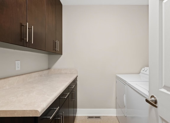 a washer and dryer in a laundry room at Cambria Luxury Apartments, Kansas City, Missouri