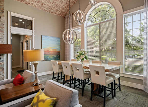 A dining room with a table set for six.