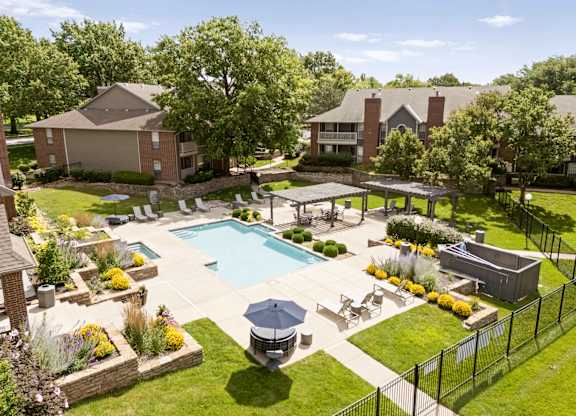 Aerial view of Highland Park's pool courtyard featuring sundeck seating and landscaped grounds.