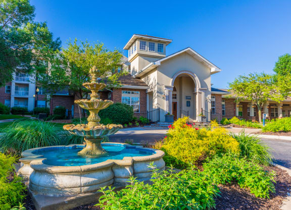 A water fountain and landscaping outside of the Claremont Apartments' leasing office in Overland Park, KS.