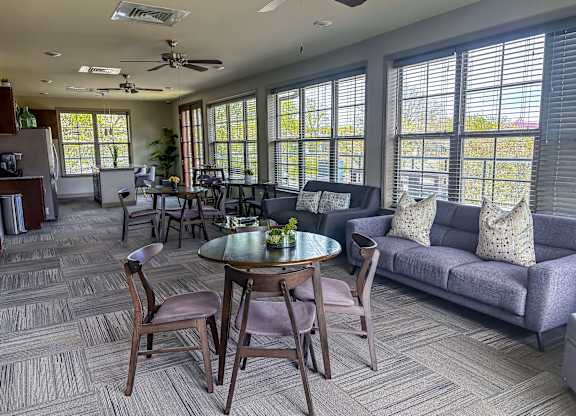 Spacious resident lounge at The Dorset Apartments featuring modern seating, large windows, and a welcoming atmosphere.