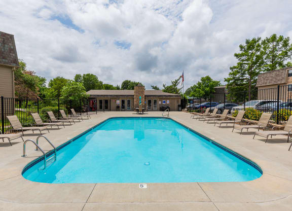 Swimming pool with lounge seating at Bristol Pointe Apartments in Olathe, Kansas.