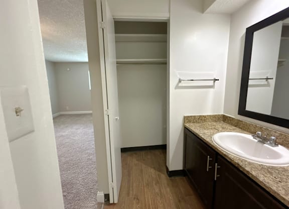 Classic Studio - Bathroom with a sink, mirror, and a closet.